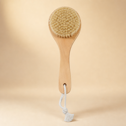 A wooden spoon-shaped body brush with natural bristles