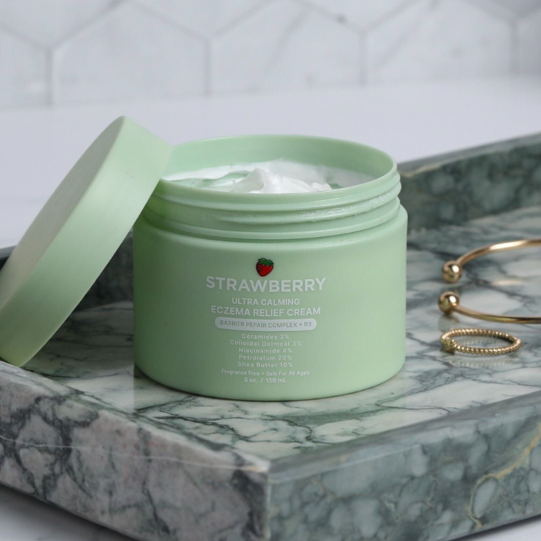 The Strawberry Advanced Barrier Repair Complex, jar open on a marble tray